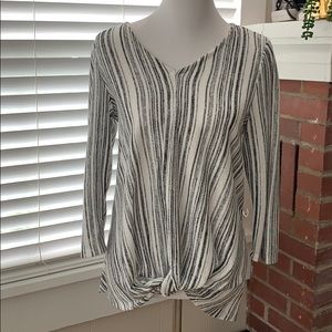 V Neck with loop through detail in front.